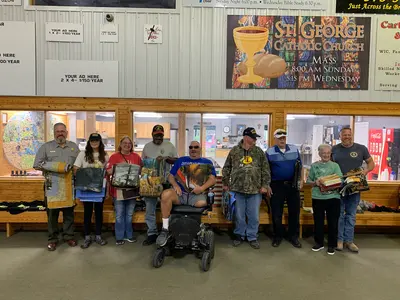 Veteran hunters, assistants and volunteers who were presented with handmade quilts from the Van Buren…