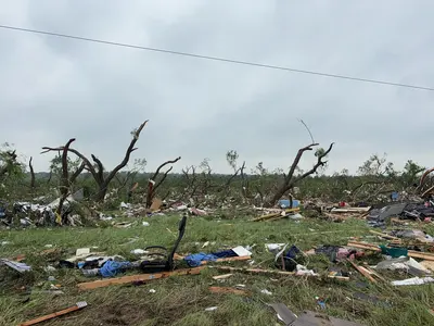 Debris of a mobile home blown into trees after an EF2 tornado in Runaway Bay, Texas